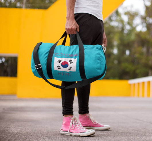 You will love Stately Wear's South Korean Flag Hippie™ duffel bag. Katie Couric Shop partner. Perfect accessory as a beach bag, ski bag, travel bag & gym or yoga bag.  Custom made one-at-a-time.  Environmentally friendly.  Biodegradable inks & dyes.  Good for the planet. 2 sizes to choose.